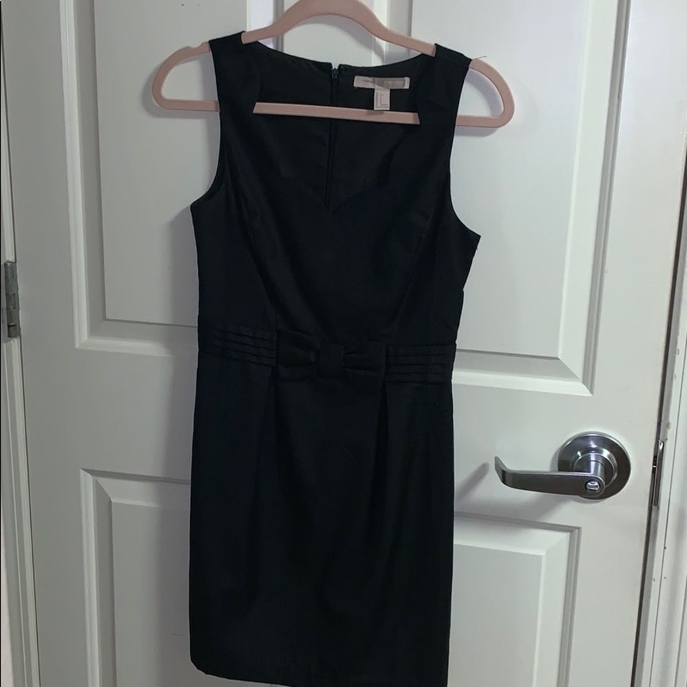 black dress with scalloping and bow